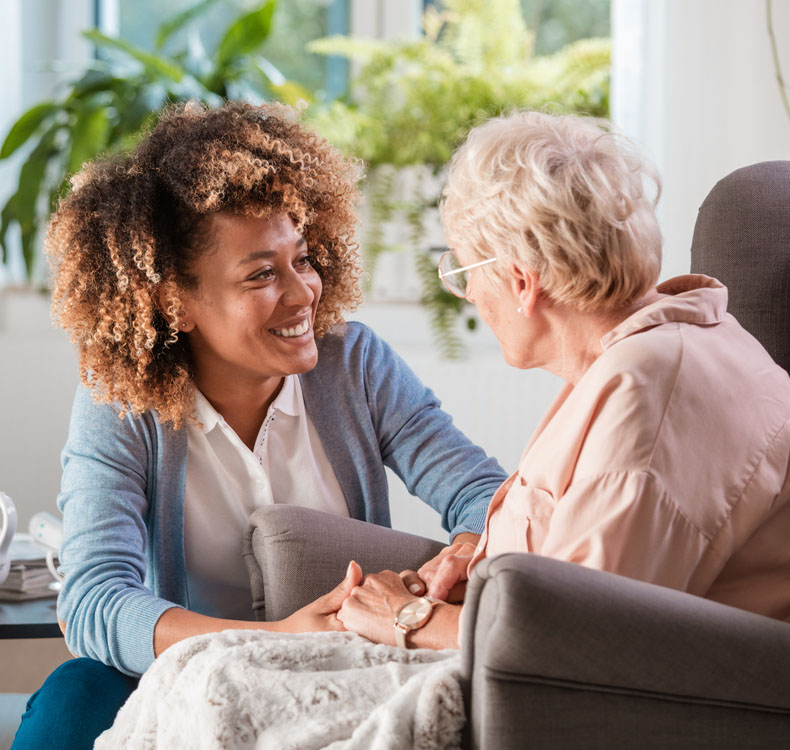 Woman speaking to an elderly woman